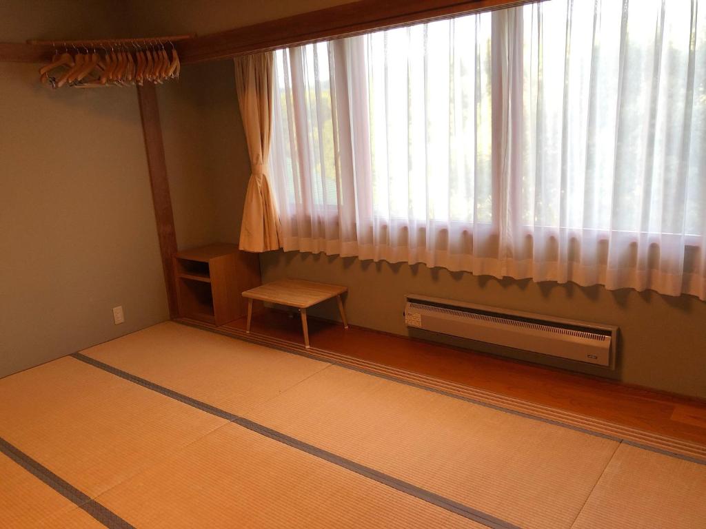 a room with a window with a radiator and a table at Aizu Kogen International Human Resources Center - Vacation STAY 44519v in Yasō