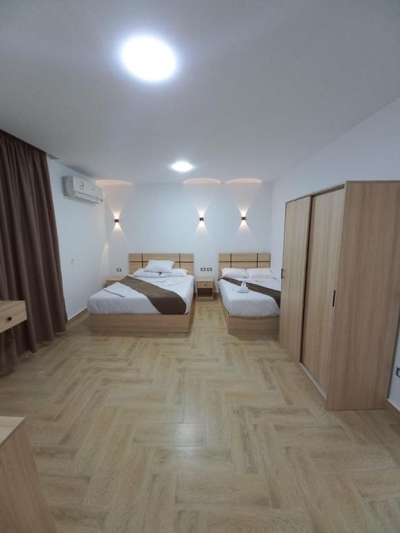 Postel nebo postele na pokoji v ubytování Malak Guest House