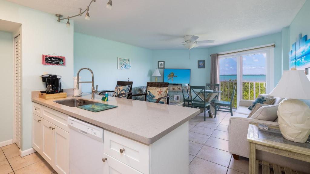 a kitchen and living room with a view of the ocean at Aqua Vista Ocean Pointe 3307 in Key Largo