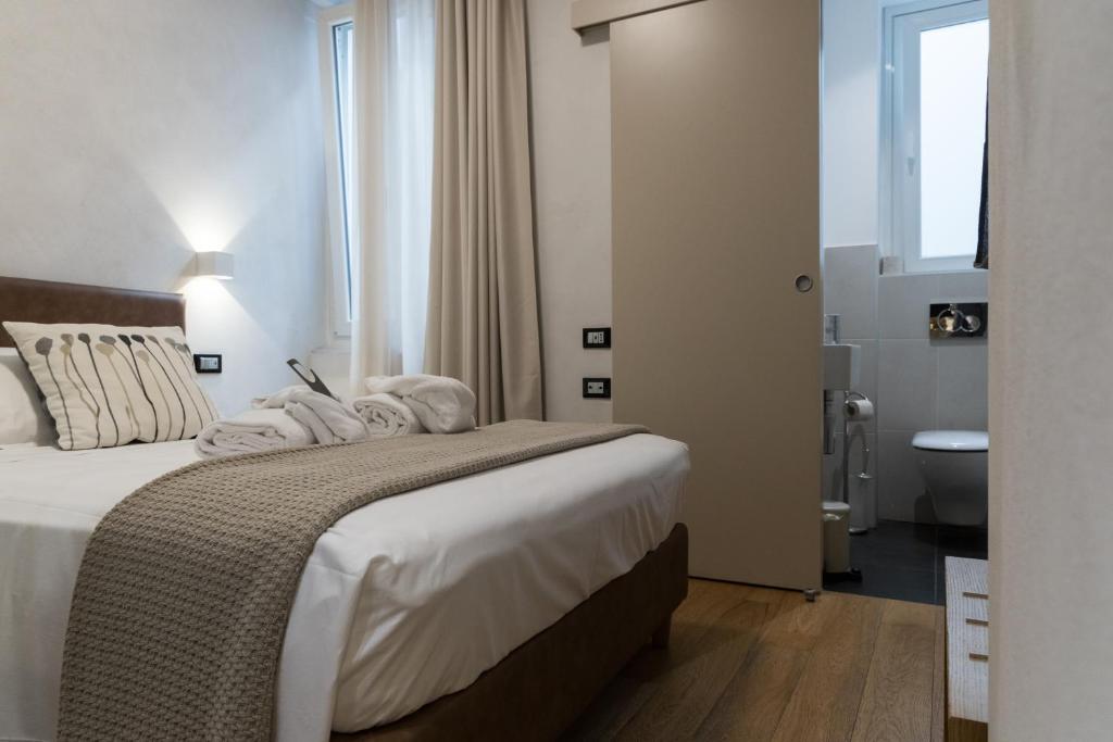Postel nebo postele na pokoji v ubytování Hotel Doria