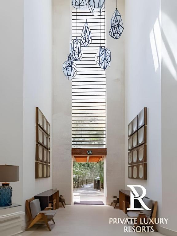 a hallway of a building with a large window at The Grand Luxxe Res Two Bedroom Loft- Riviera Maya in Nuevo Vallarta