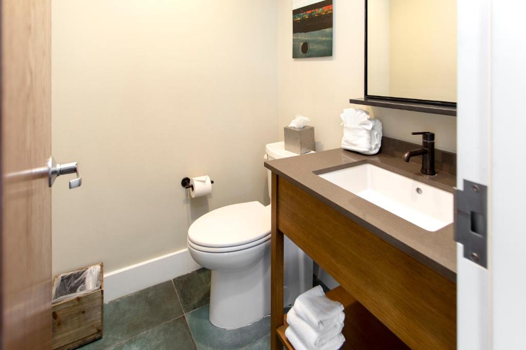 a bathroom with a toilet and a sink at The Perry Hotel & Marina Key West in Key West