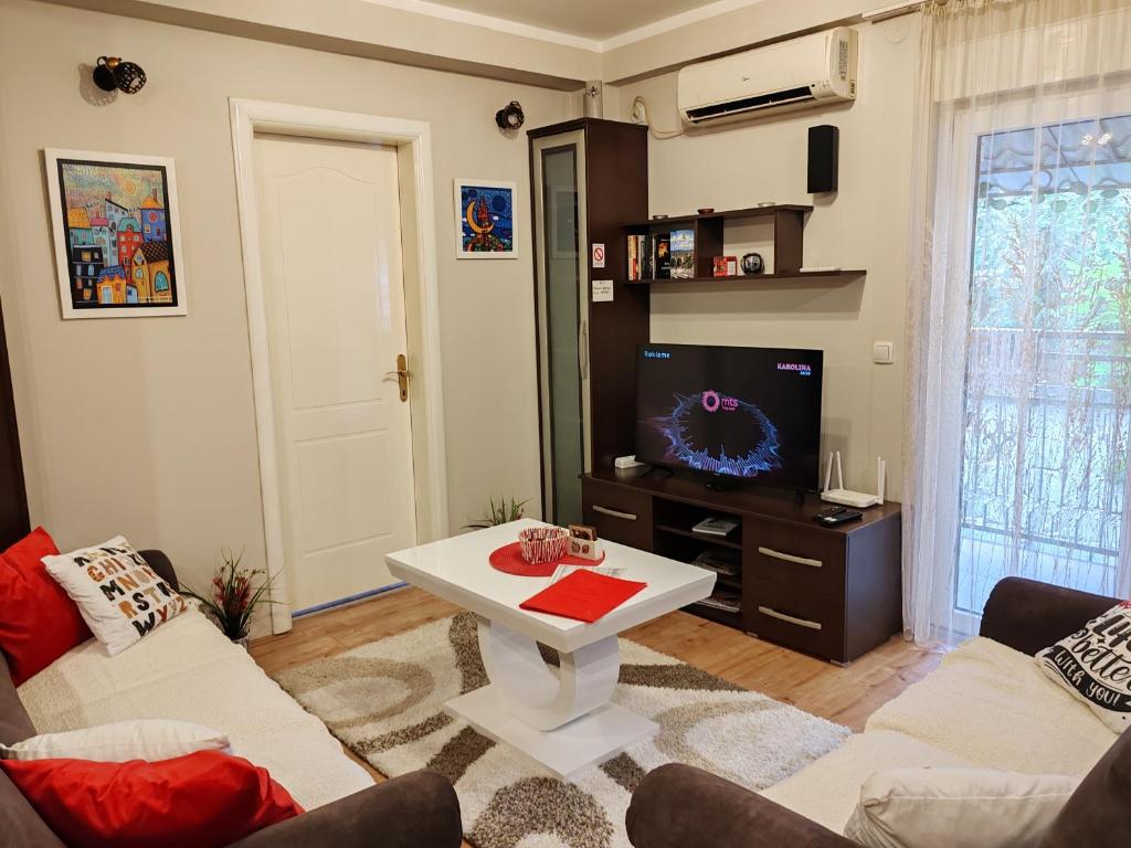 a living room with two couches and a tv at Memento in Kragujevac