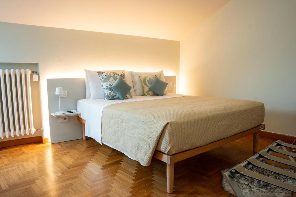 a bedroom with a large bed with pillows at LHE Maison Almerici in Cesena