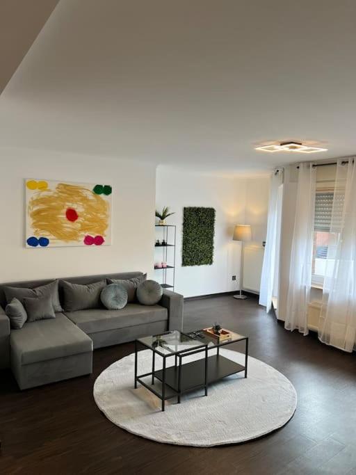 a living room with a couch and a table at Hochwertige Wohnung Frechen City in Frechen