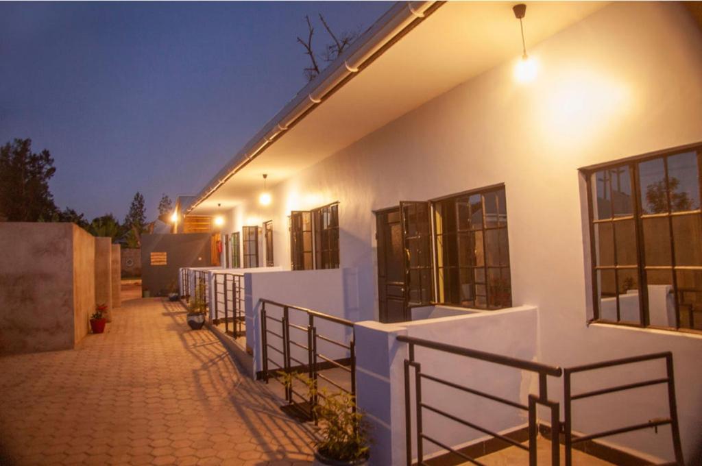 a white building with windows and a walkway at Shavia Lodge in Arusha