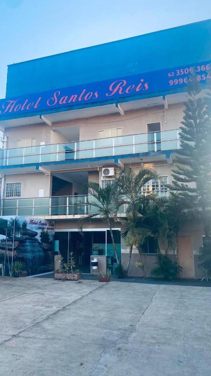 a building with a sign on the side of it at Hotel Santos Reis in Trindade