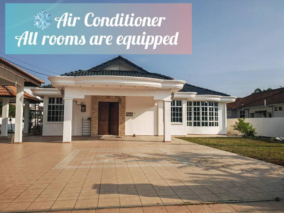a house with the words air conditioning all rooms are equipped at Cozy Deluxe House Padang Serai 28pax in Padang Serai