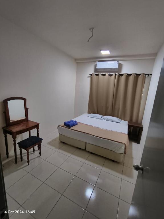 a bedroom with a bed and a chair and a window at Mama Homestay -Near UiTM and Hospital in Bandar Puncak Alam