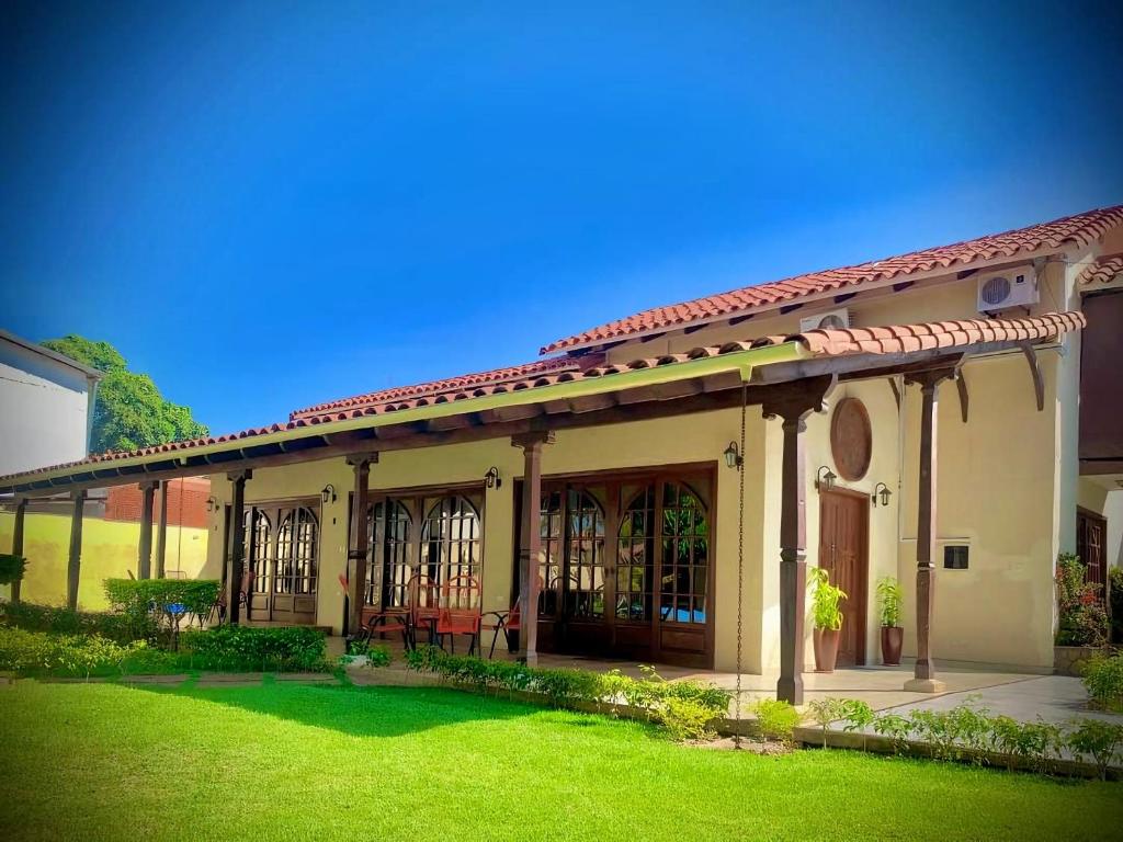 a house with a green lawn in front of it at The House Of Don Lucho in Santa Cruz de la Sierra