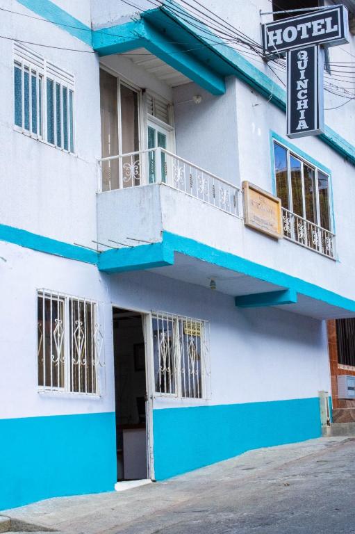 a blue and white building with a balcony at Hotel Quinchia in Quinchía
