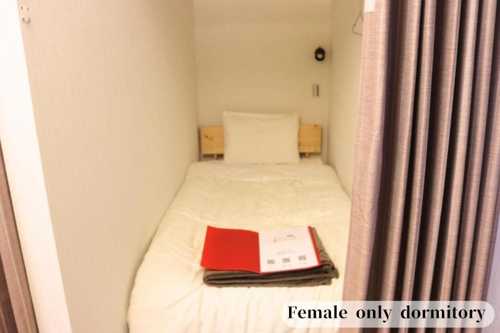 Postel nebo postele na pokoji v ubytování GUESTHOUSE富士と碧