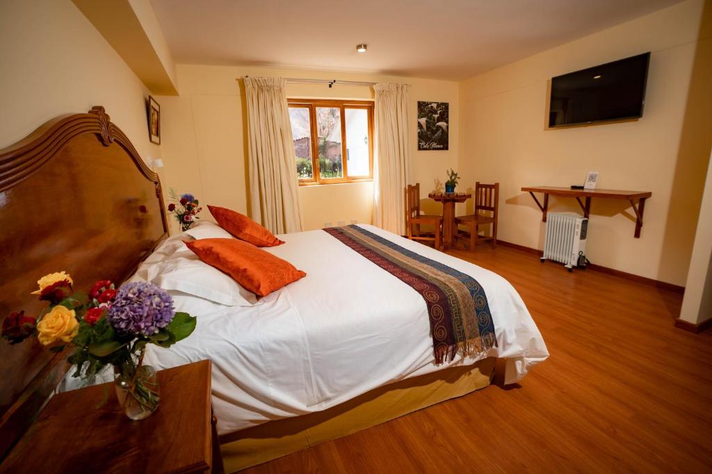 Postel nebo postele na pokoji v ubytování Hotel Agustos Urubamba