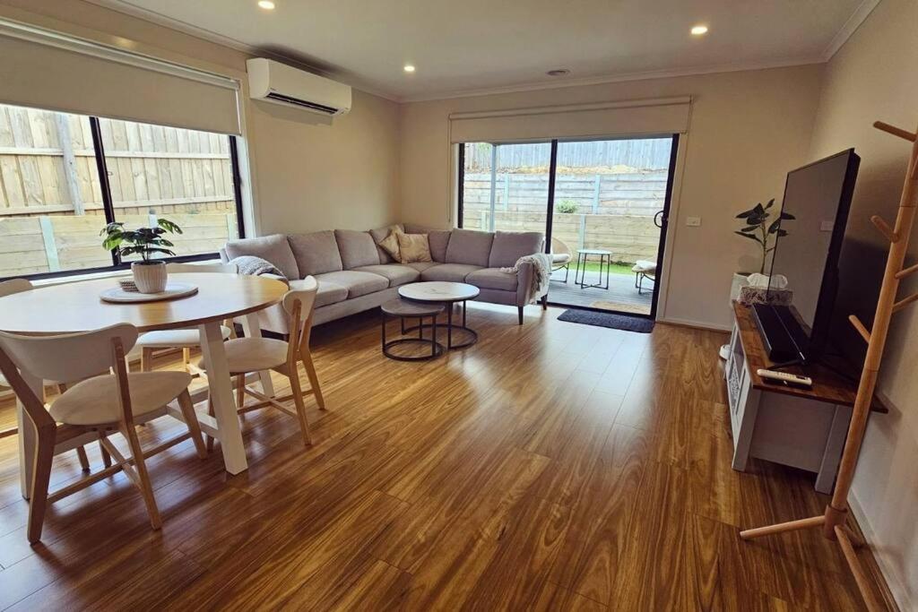 MoeGetaway on Amaroo Way的带桌子和沙发的客厅
