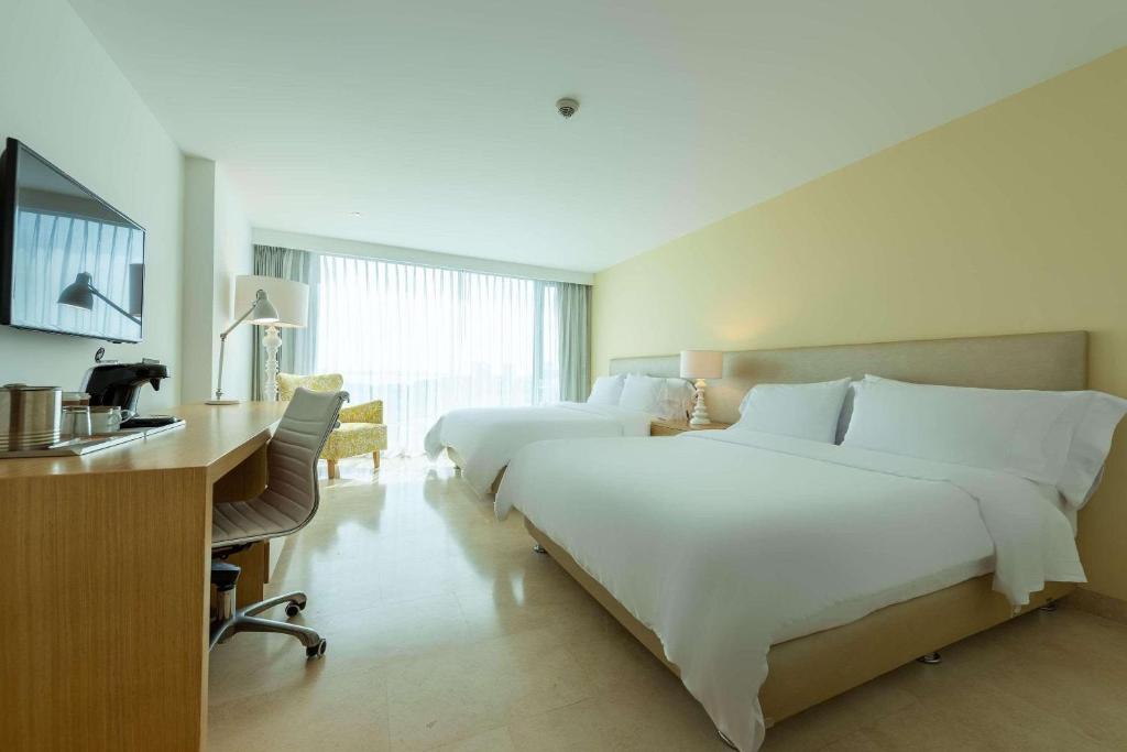 Postel nebo postele na pokoji v ubytování Radisson Cartagena Ocean Pavillion Hotel