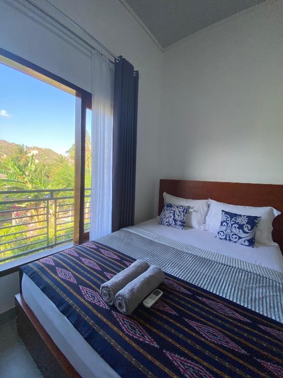 Postel nebo postele na pokoji v ubytování Cewin's Homestay