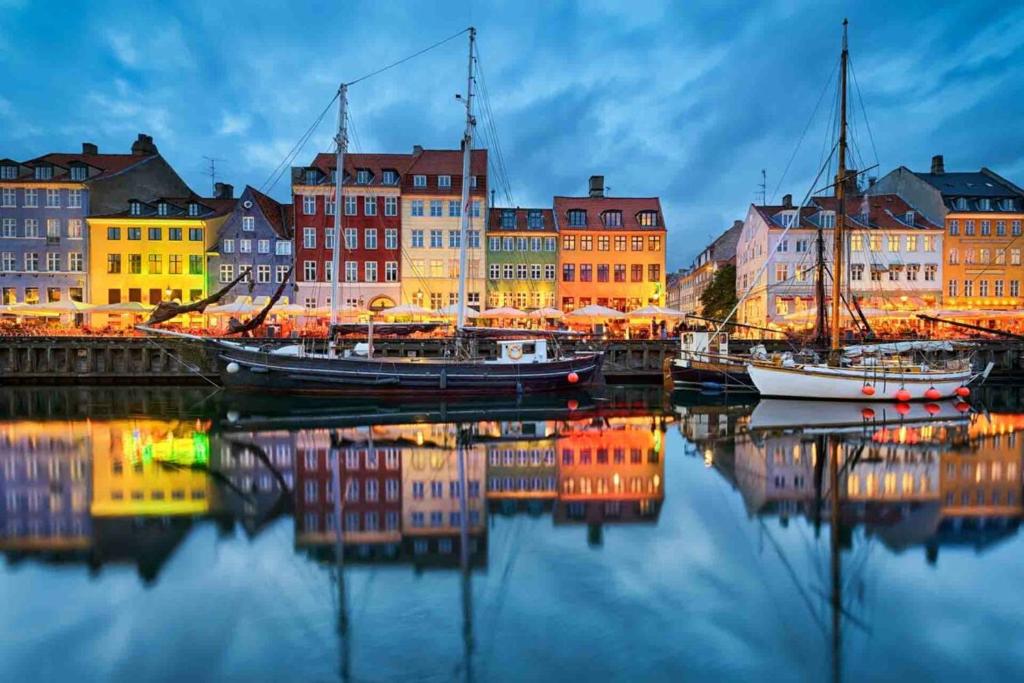 a group of boats docked in a harbor with buildings at Stevns Camp in Strøby