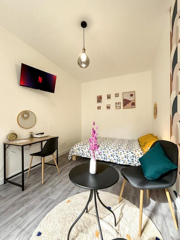 une chambre avec un lit, une table et des chaises dans l'établissement Cosynist, à Choisy-le-Roi