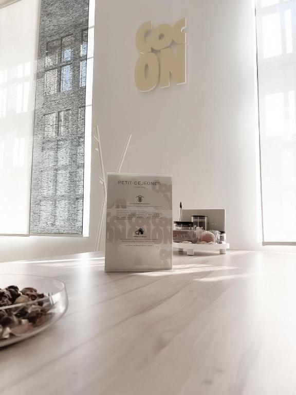 a white room with a plate of food on the floor at Le Petit Cocon - Pause douceur in Cambrai