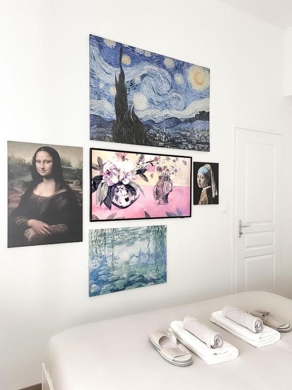 a room with four pictures on the wall at Le Petit Cocon - Pause douceur in Cambrai