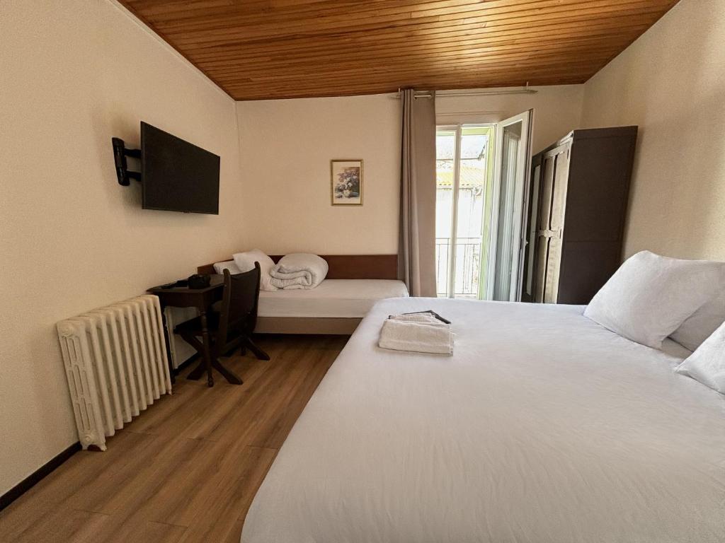 Postel nebo postele na pokoji v ubytování Hôtel Restaurant Le Botaniste