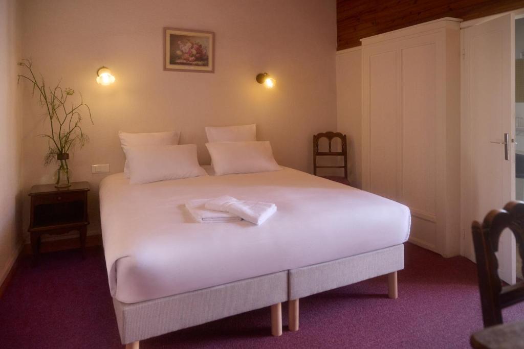 Postel nebo postele na pokoji v ubytování Hôtel Restaurant Le Botaniste