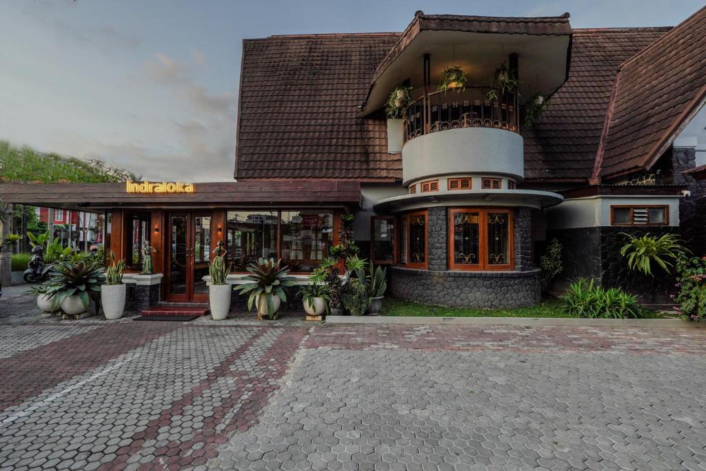a building with a clock tower on top of it at Indraloka Heritage Homestay in Yogyakarta