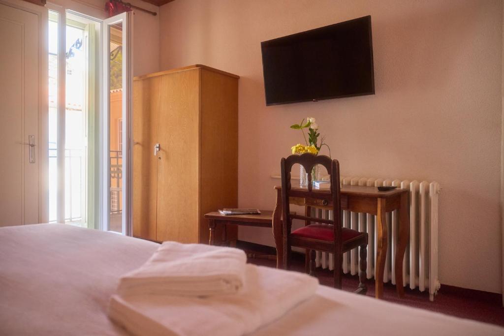 Postel nebo postele na pokoji v ubytování Hôtel Restaurant Le Botaniste