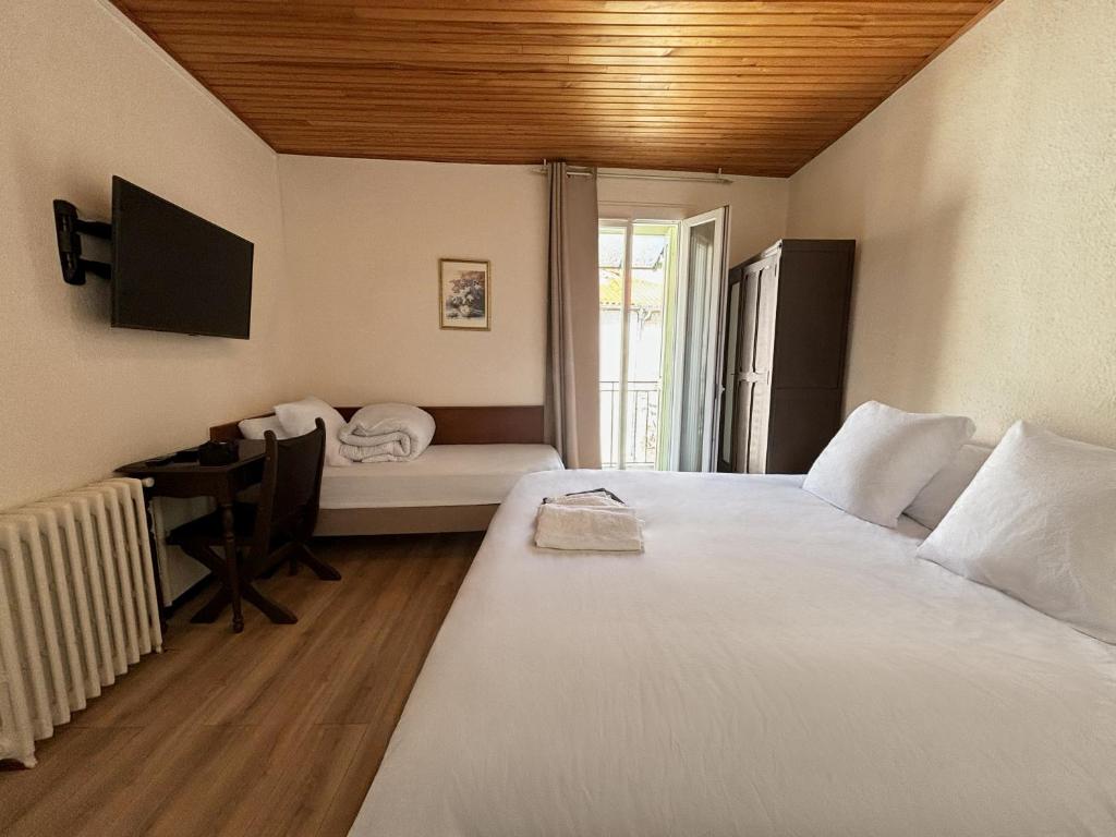 Postel nebo postele na pokoji v ubytování Hôtel Restaurant Le Botaniste