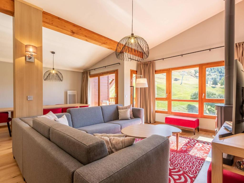 a living room with a couch and a table at Duplex 4 chambres avec piscine, spa et parking aux Arcs 1800 - FR-1-352-55 in Arc 1800