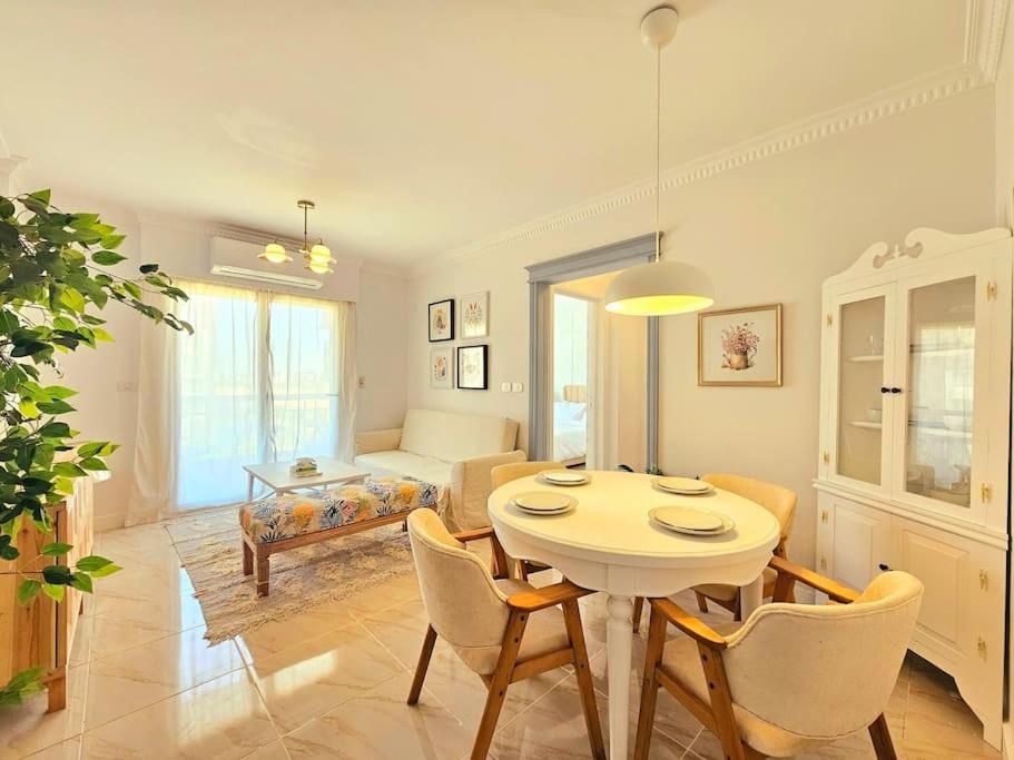 a living room with a table and chairs and a couch at Our home Our heaven in Madinaty