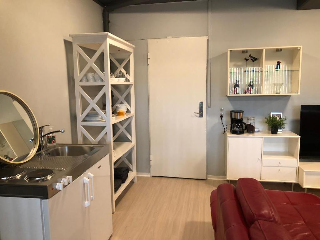 a kitchen with a sink and a door to a room at Struer udlejning - lejlighed 1 Bredgade 62 C in Struer