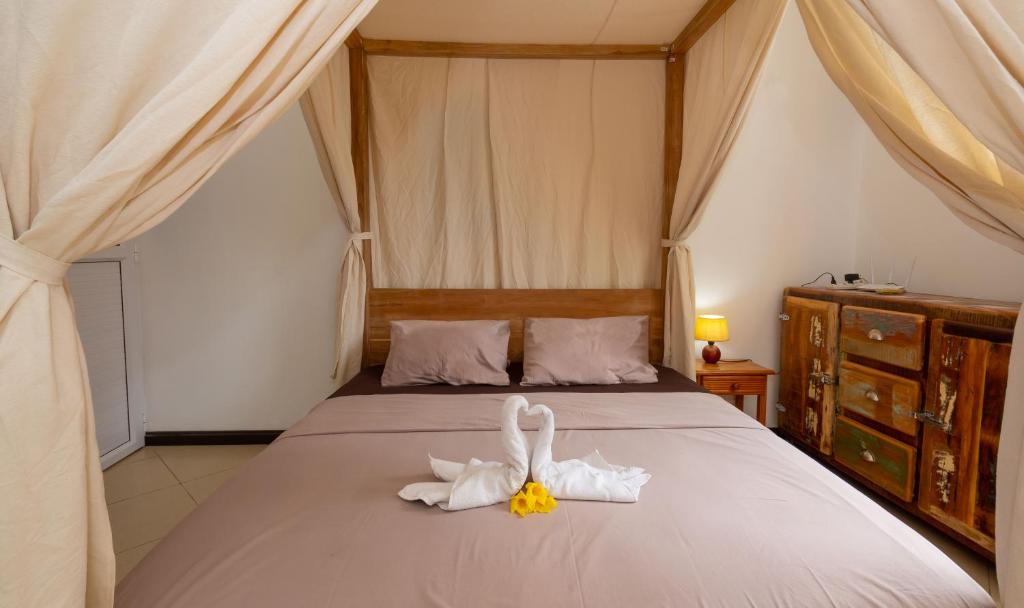 Postel nebo postele na pokoji v ubytování Twakila Sunset Suites