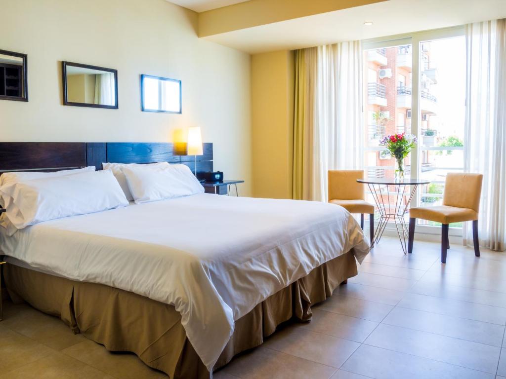 a bedroom with a large bed and a table at Two Independent Palermo Hollywood Studios at Buenos Aires's Best Neighborhood in Buenos Aires