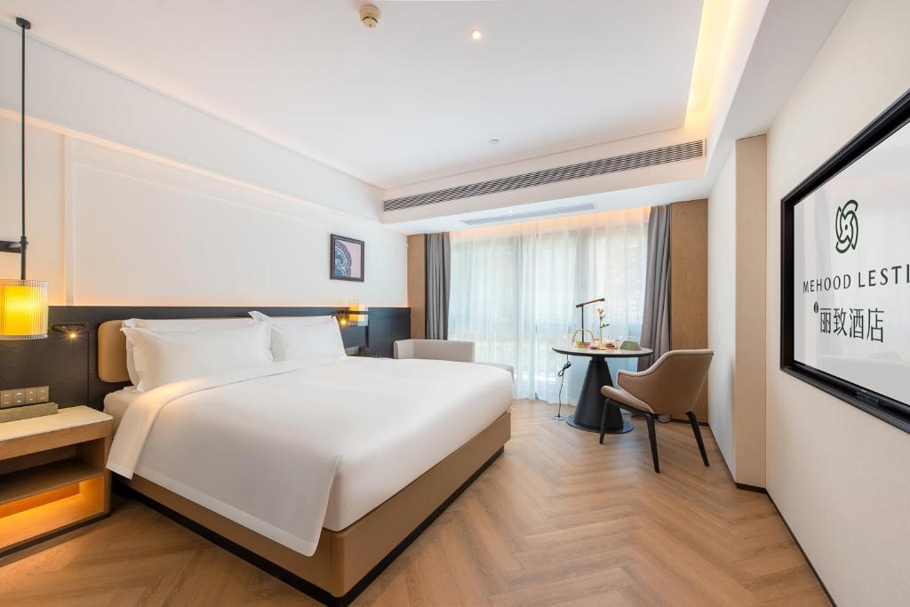 Postel nebo postele na pokoji v ubytování Mehood Lestie Hotel Pazhou Convention and Exhibition Center Branch - Free Shuttle Bus to Canton Fair Complex During Canton Fair Period