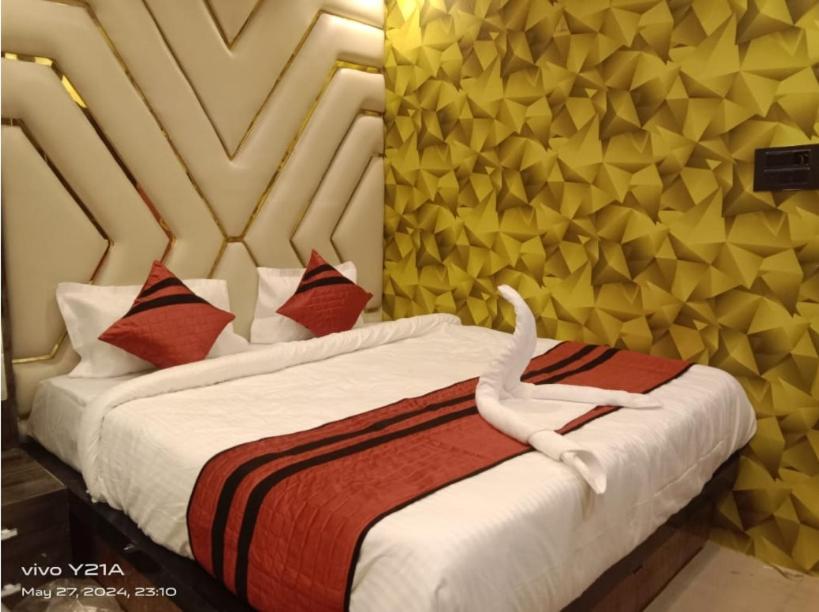 a bedroom with a bed with a white snake on it at Hotel Ganpati in Patna