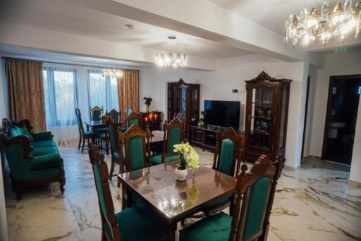 a living room with a table and chairs and a dining room at Agropensiunea Casa Daiana Breb in Breb