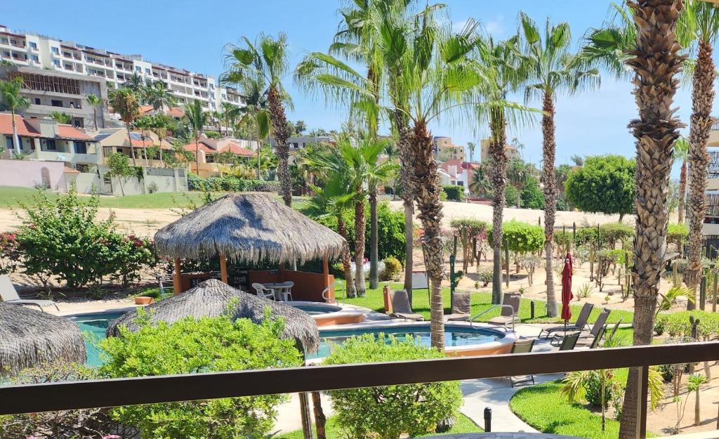 a view of a resort with a swimming pool and palm trees at Beach Eateries Shops 10 min walk Golf view in San José del Cabo