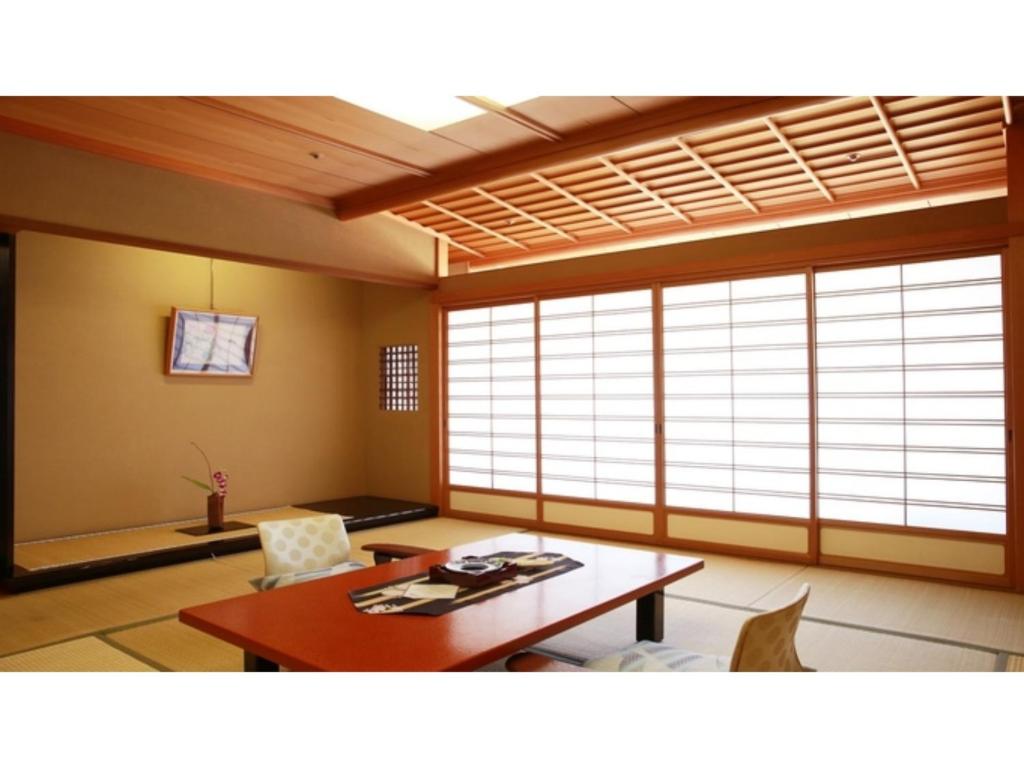 a living room with a table and some windows at Tokigasane - Vacation STAY 21015v in Kaga