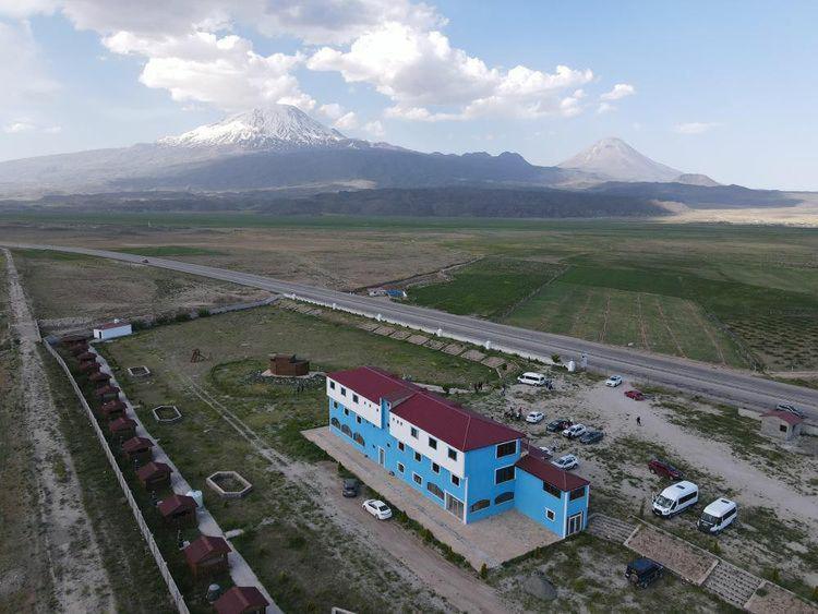 an aerial view of a building with a mountain in the background at Parasut Village Hotel in Kargakonmaz