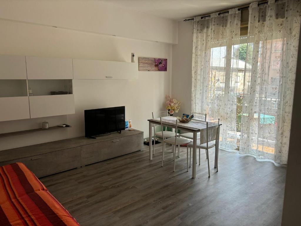 a living room with a table and a television at Casa Smile in Legnano