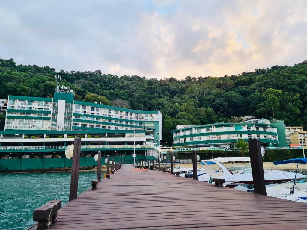 a dock with buildings on a body of water at Angra dos reis, Praia Grande cond-angra inn in Angra dos Reis