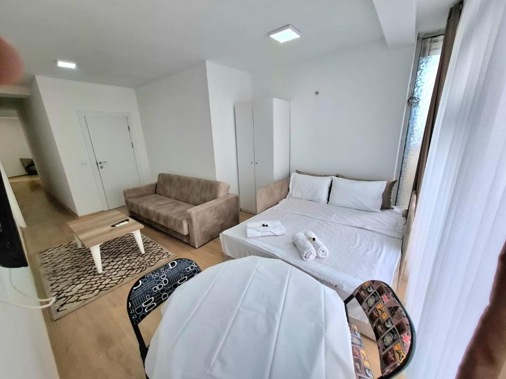 a small room with a bed and a couch at Rooms & Apartment Struga in Struga