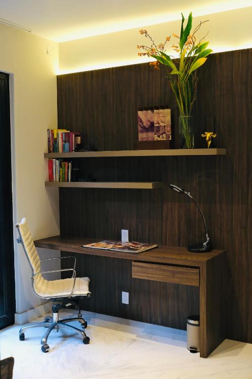 A built-in home-office desk with an ergonomic chair, shelves and task lamp.