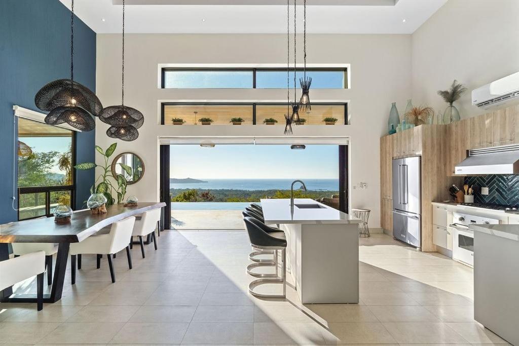 a kitchen and dining room with a view of the ocean at Sunset Infinity Pool & Private Ocean Views in Brasilito