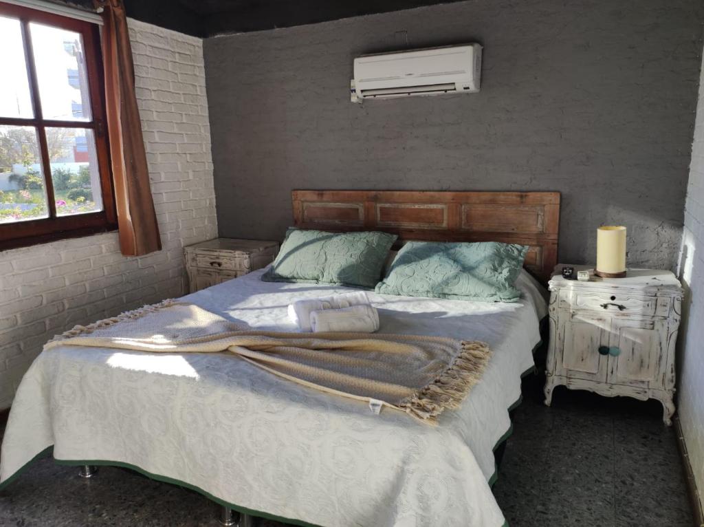 a bedroom with a bed and a window at PASTORA Suites & Hostel - Punta del este in Punta del Este