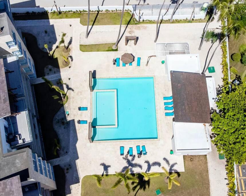 an overhead view of a swimming pool in a yard at Corals Retreat 2BR Beach Condo in Punta Cana