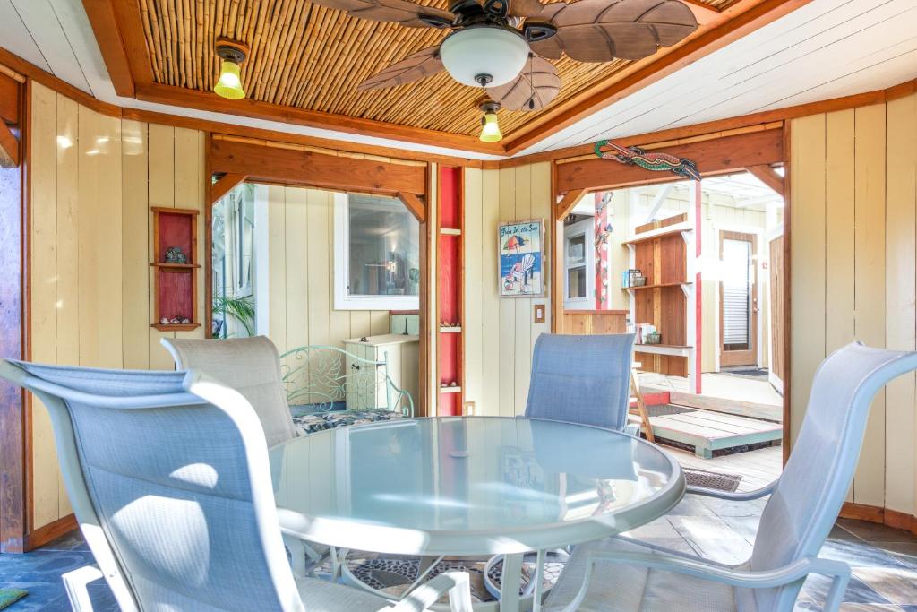 a dining room with a glass table and chairs at Pahoa Sunrise Paradise Gardens in Pahoa