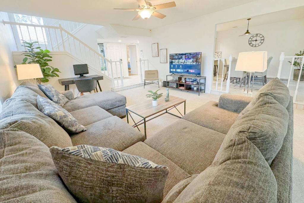 a living room with a couch and a tv at Canopy on Cobblestone in Wesley Chapel
