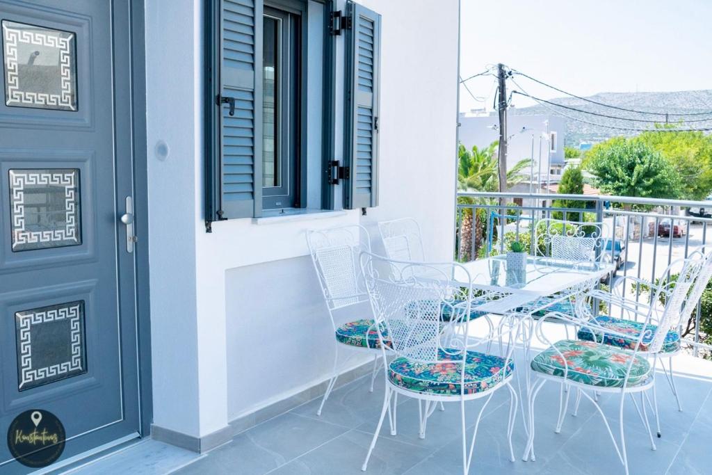a patio with chairs and a table on a balcony at Seaside Apartments in Emporeios